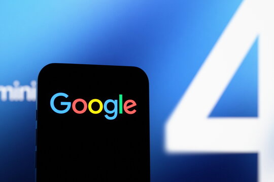 High-angle view: the Google logo displayed on a smartphone screen. Google unveils its new Gemini 4 Argon AI model. October 1, 2026, Lisbon, Portugal.