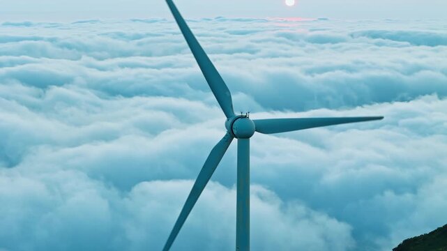 Wind turbine rotor above clouds, Madeira island. Transition to low carbon energy system and renewable sources