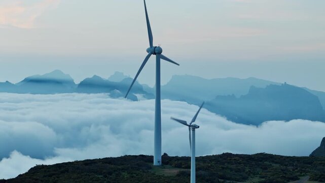 Aerial view of wind turbines above clouds on Madeira island, sustainable power infrastructure in Portugal