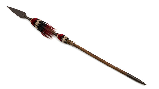 Traditional tribal spear with decorative fur and long wooden shaft isolated on white background