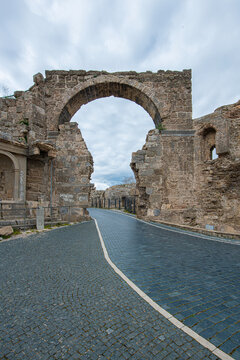 Side Ancient City. It shows the remains of an ancient structure and a stone-paved road passing through them. As indicated in the file name, these remains belong to the Vespasian Fountain and the Monum