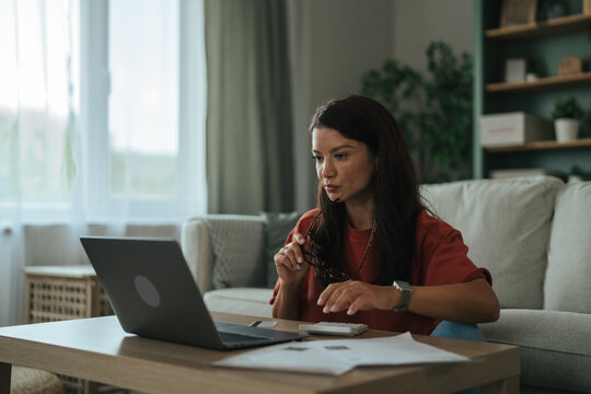 Woman managing personal finances and budget using laptop