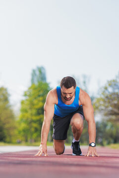 Man in a starting position ready to run