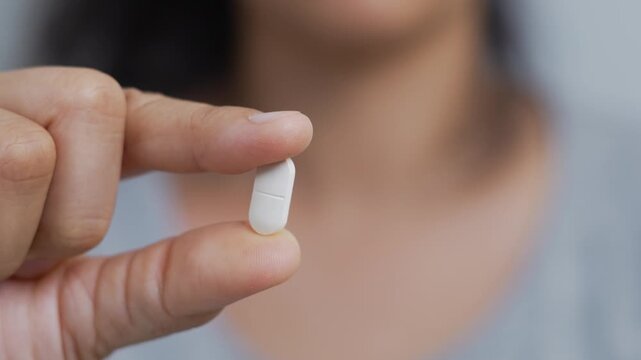 close up woman hand holding a medicine. Stop drug use Taking Medication Caring for the health care medical concept.