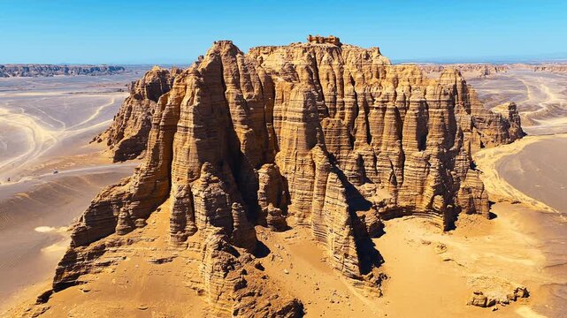 High-angle shot showcases towering yardang rock formations under a bright blue sky in Dahaidao, Xinjiang.