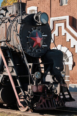 Steam locomotives with red star stands on the railroad tracks in the museum exposition. Locomotive depot, railway in the city. © VLAD ANTONOV