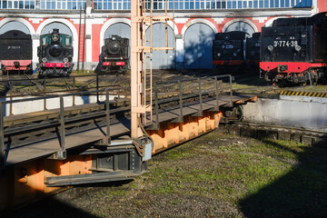Retro steam train. Locomotive depot, railway in the city.Special circular rotating platform with rails, used for distributing locomotives within a depot and for repair purposes © VLAD ANTONOV