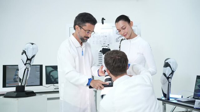 Research team collaborates in a modern laboratory, testing and examining an advanced robotic prosthetic limb together to drive innovation in medical technology and engineering.