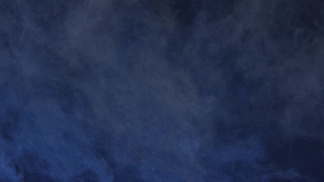 Dark blue smoke and hazy atmospheric fog swirl smoothly across a horizontal frame in an abstract 3D visual background