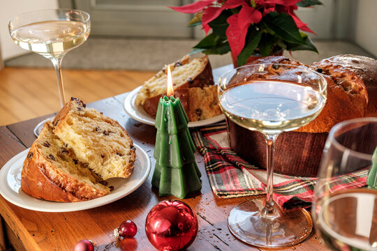 Festive Holiday Table With White Wine Glasses, Cheese Board, Olives and Christmas Tree Decorations