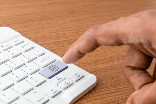Human hand pressing a dedicated AI button on a white computer keyboard. Artificial intelligence integration, future technology, automation, smart software concept.