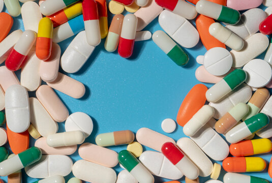 Flat lay colorful medical pills and capsules with copy space. Healthcare, pharmacy, medication, pharmaceutical industry concept.