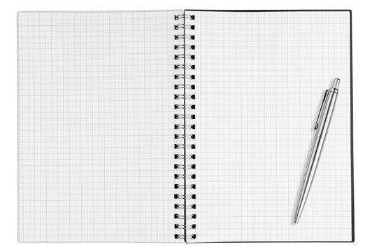 Blank open vertical graph notebook with checkered pages and silver ballpoint pen isolated on white background. Top view portrait notepad mockup template for business, accounting and coding