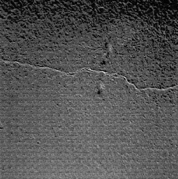 Cracked earth texture displays a dry arid landscape with fractured soil