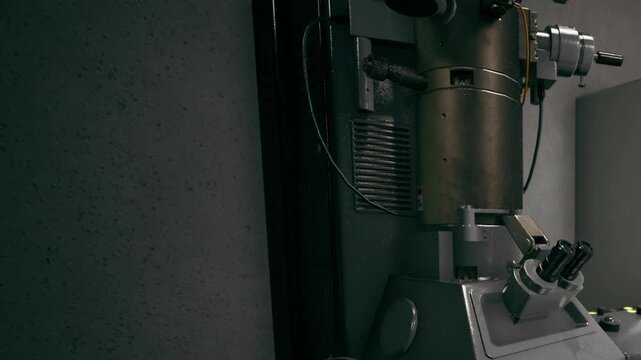 A sleek, high tech machine stands in a dimly lit laboratory. Its metallic surface gleams under ambient lights, showcasing the intricate design and engineering.