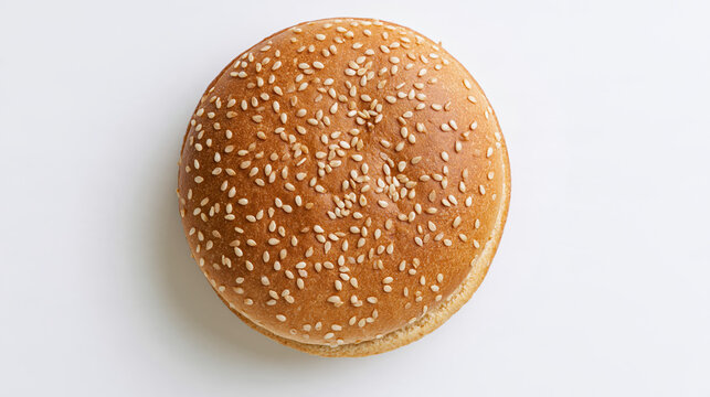 Sesame burger bun viewed directly from above with warm baked color and crisp seed topping
