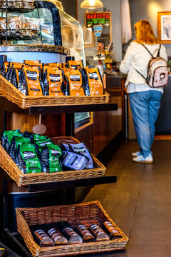 Interior Of A Caffe Nero Coffee Shop With A Display Of Branded Retail Coffee Bags And A Customer Waiting At The Counter