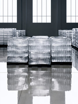 Warehouse inventory featuring multiple pallets of shrink wrapped bottled water in clean industrial storage facility