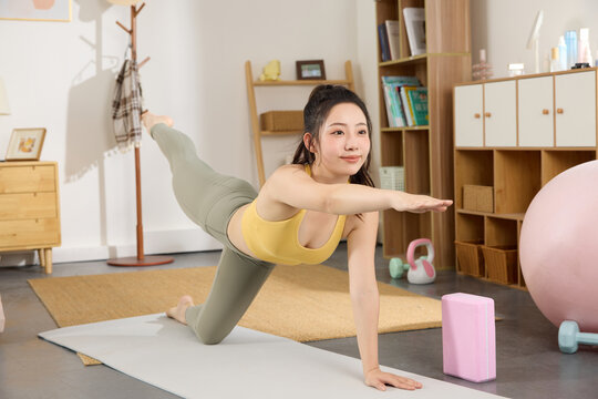 Woman Practicing Side Plank Yoga Pose in a Cozy Living Room at Home
