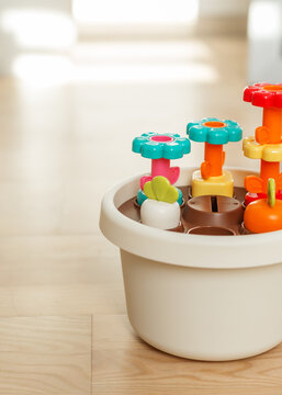 Colorful flower shape sorter toy close-up on wooden floor