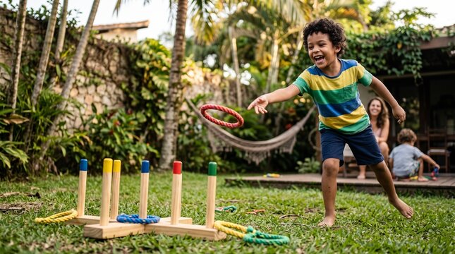 Joyful young boy playing ring toss game in a lush green backyard with family watching
