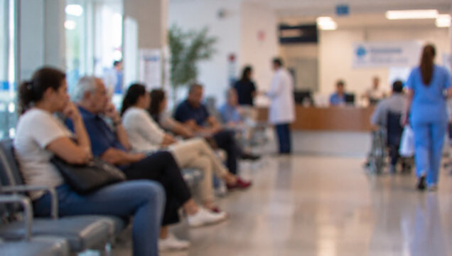 Patients and Family Members Sitting in Modern Hospital Waiting Room Blurred Scene