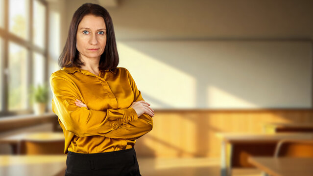Female teacher or lecturer in classroom &ndash; education and academic learning concept.
