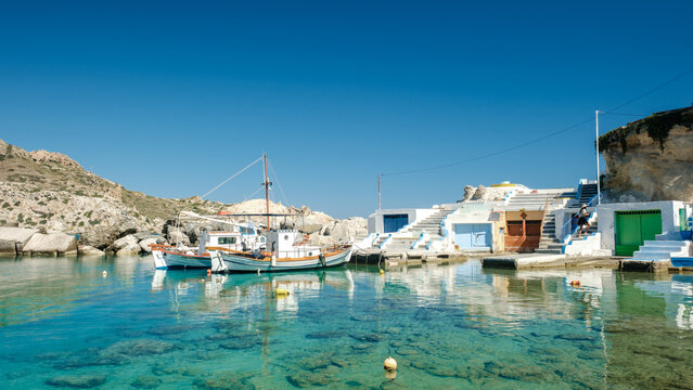 Charming Mandrakia fishing village in Milos, Greece with stunning blue waters