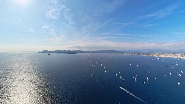 Aerial view of a sailing regatta in the Bay of Cannes, low altitude flight from plane, 
