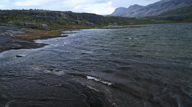 Low Aerial Flight Over Mountain Lake and Granite Cascade in Norwegian Wilderness Rago Park