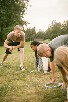 Camp counselor instructing children at starting line before race