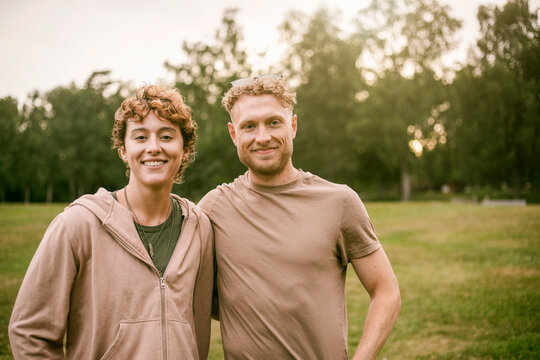Portrait of male and female camp counselors standing together at park