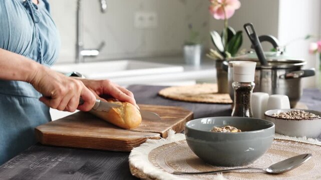 Woman Slicing Baguette Preparing Breakfast Close-Up