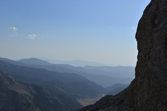 Natural Mountain Vista with Rocky Terrain, Evergreen Trees, and Atmospheric Depth