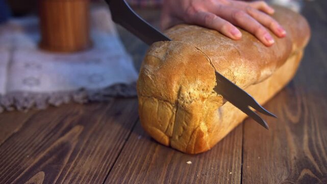 woman hands slicing bread