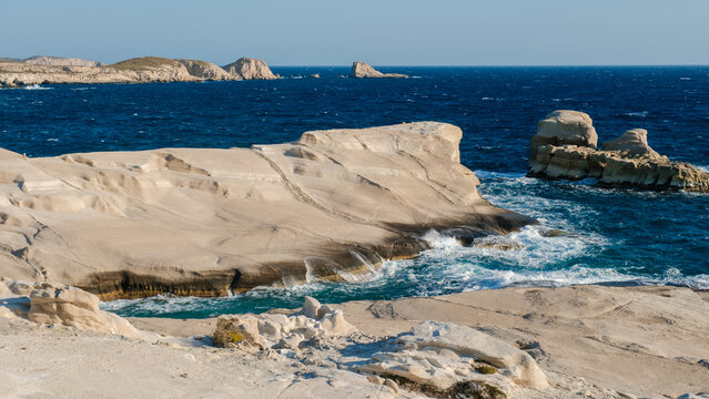 Stunning rocky coastline of Sarakiniko in Milos, Greece with turquoise waters and blue skies