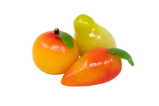 Three miniature Thai luk chup mung-bean sweets shaped as tiny glossy Isolated on White Background