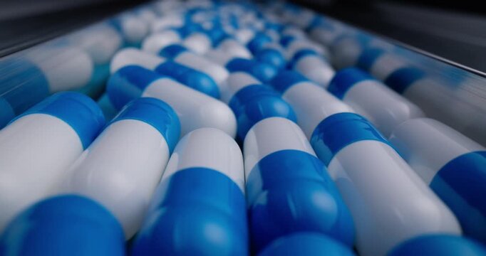 Probe view blue and white capsule rows on stainless conveyor in pharmaceutical production line for packaging medical.