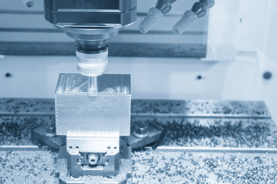 CNC milling machine rough cutting mold parts with an indexable tool in a light blue scene