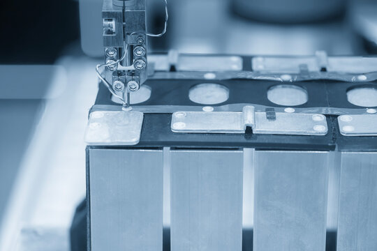 Automated robotic system operating the EV car battery pack assembly process in a blue tone scene