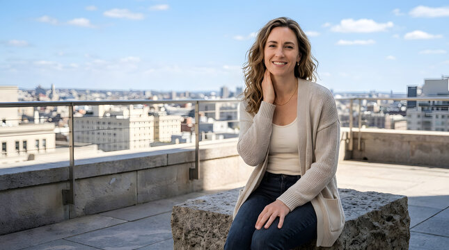 Woman, people and city skyline with smile, professional look and casual clothing outdoors. Lifestyle, person and business portrait on balcony with apartment background and landscape view at daytime i