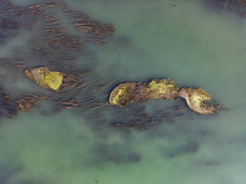 Aerial view of the Buna-Drin River Confluence featuring clear greenish water and submerged aquatic vegetation in Zues, Qarku i Shkodres, Albania.