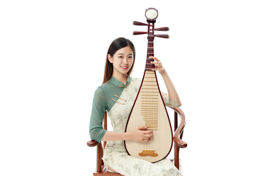 Young woman in traditional Chinese dress holding pipa on white background