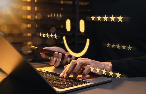Customer satisfaction and five star review concept. Person using laptop and smartphone, smile icon, service quality, customer feedback, loyalty, engagement, reputation, positive business experience