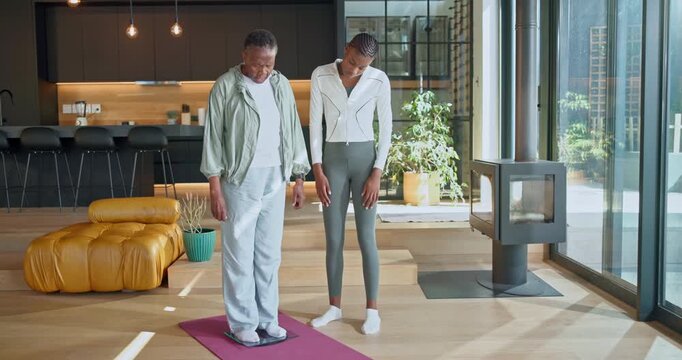 Scale, disappointment and old woman in home with personal trainer, weight gain or advice for fitness. Unhappy, senior black person and coach talk in house with body mass machine, diet fail and issue.