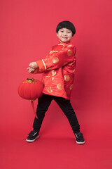Smiling Boy in Traditional Red Chinese Outfit Holding a Lantern for Lunar New Year © TuBichHong