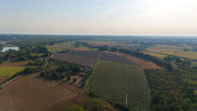 Aerial view of the Po River with low water levels due to drought, exposing sediments, beaches, and riverbed in the rural landscape of Castelvetro Piacentino, Emilia-Romagna, Italy.