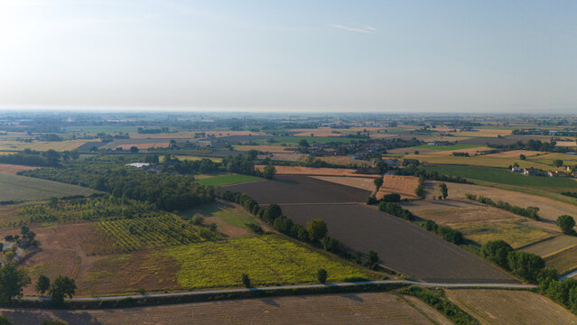 Aerial view of the Po River landscape during a summer heatwave with low water levels exposing dry riverbeds and agricultural fields in Castelvetro Piacentino, Emilia-Romagna, Italy.