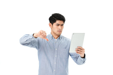 Unhappy Young Man Showing Thumbs Down While Looking at Tablet © HaXuanDieu