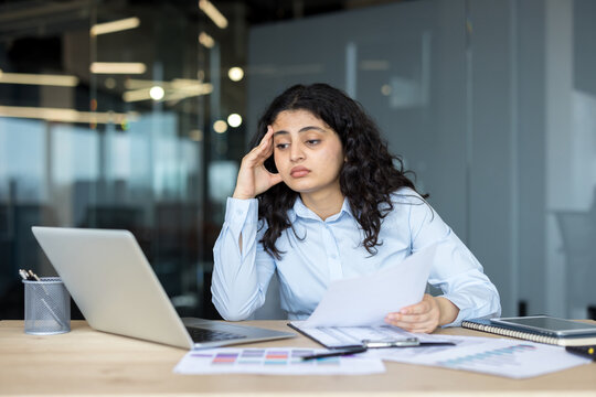 Stressed woman experiencing burnout during overwhelming office work